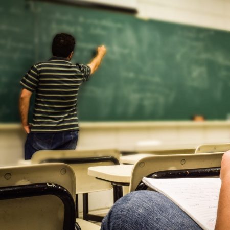 man-in-black-and-white-polo-shirt-beside-writing-board-159844