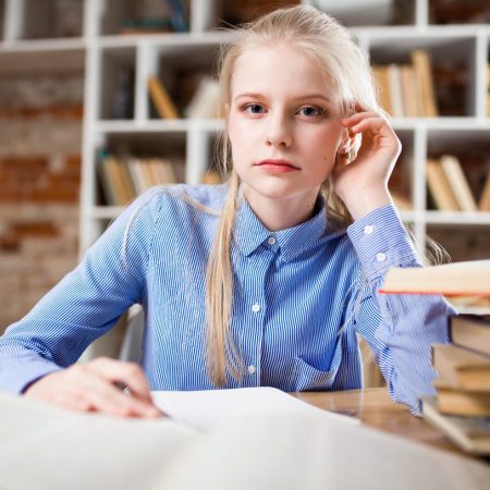 woman-sitting-next-to-table-and-right-hand-on-ear-1326946